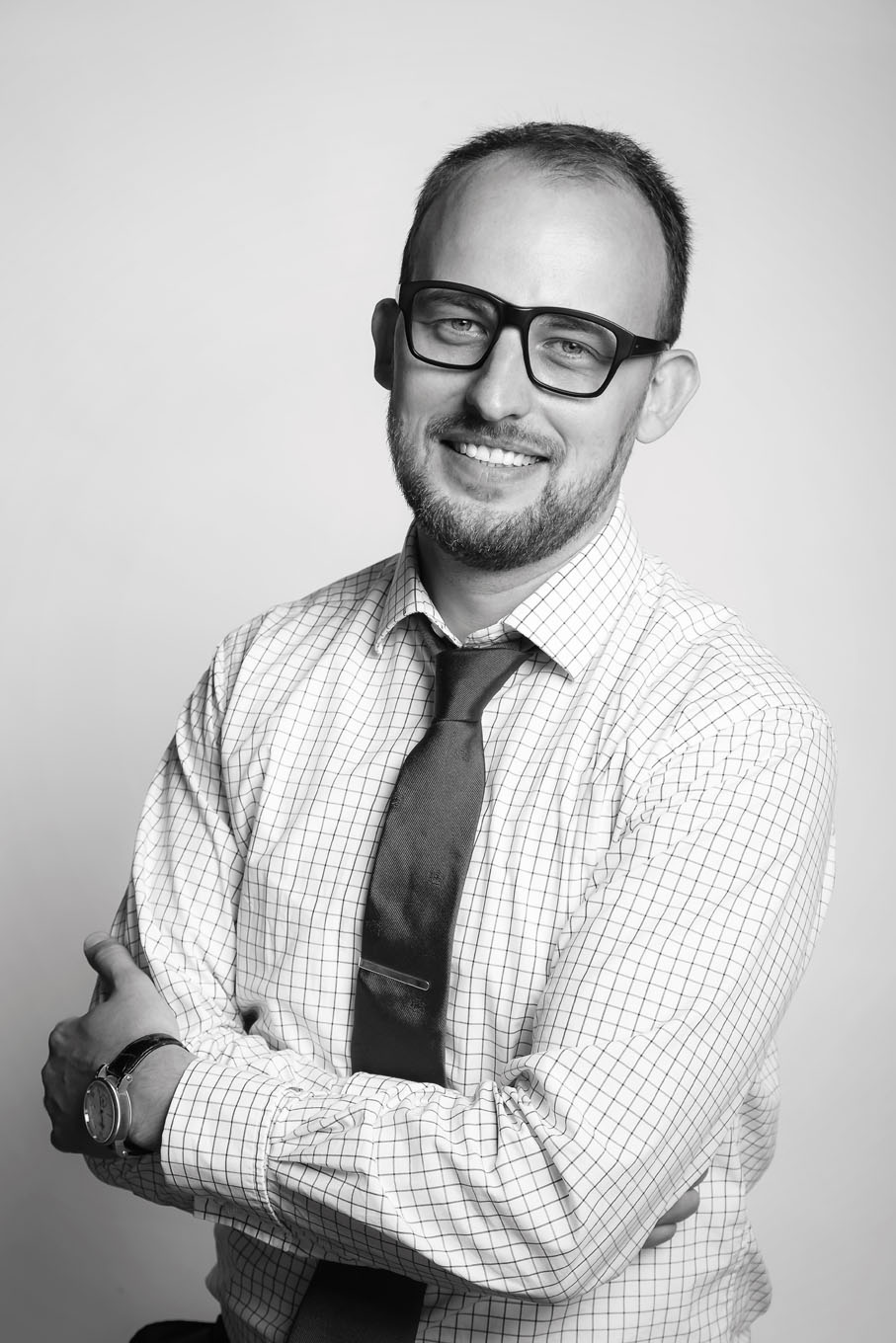 A portrait of a a man taken in a studio set up with backdrop and lighting equipment